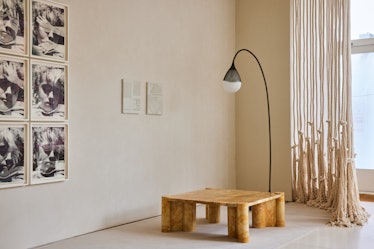 Work installed in one of the rooms of Egg Collective’s Tribeca space with a lamp and a small wooden ...
