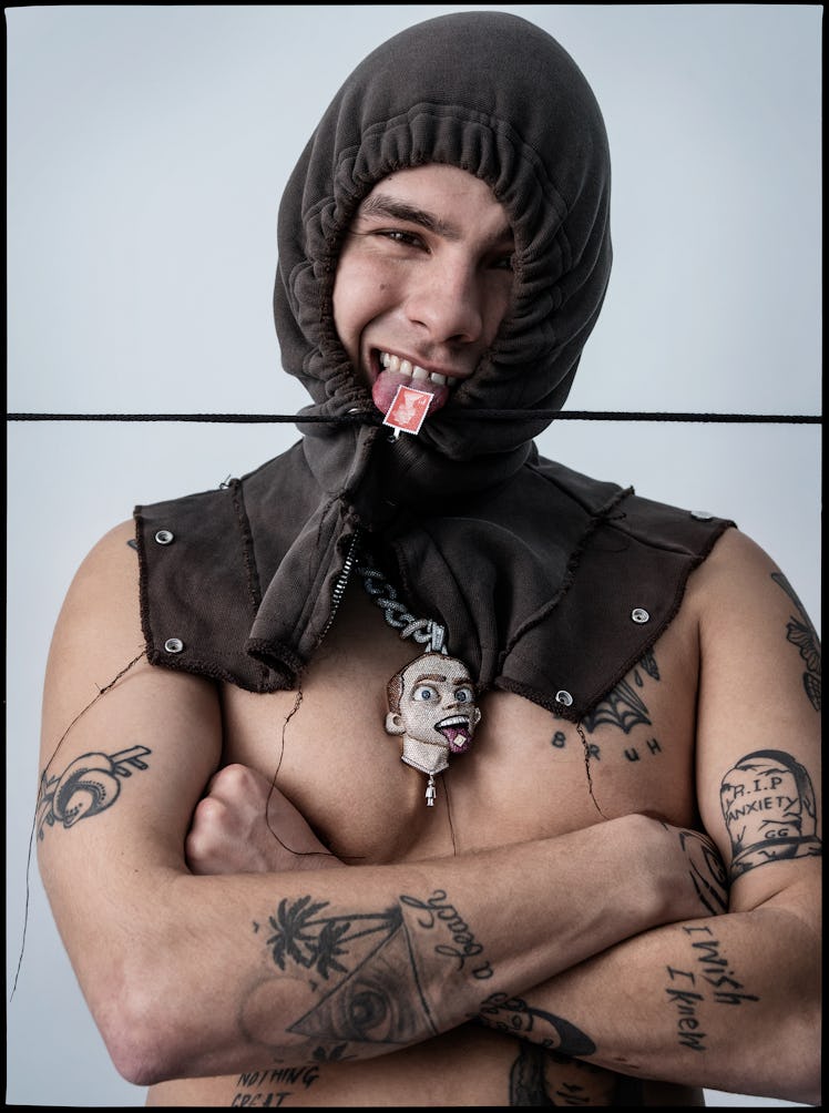 Slowthai wears a Givenchy hood; his own necklace (throughout).