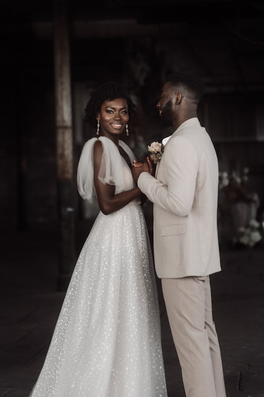 Groom gazing at bride, who is wearing graduated drop earrings. Photographer @emmaryanphotographer  P...