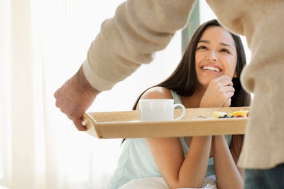 Spoiled young woman getting breakfast in bed, per her zodiac sign