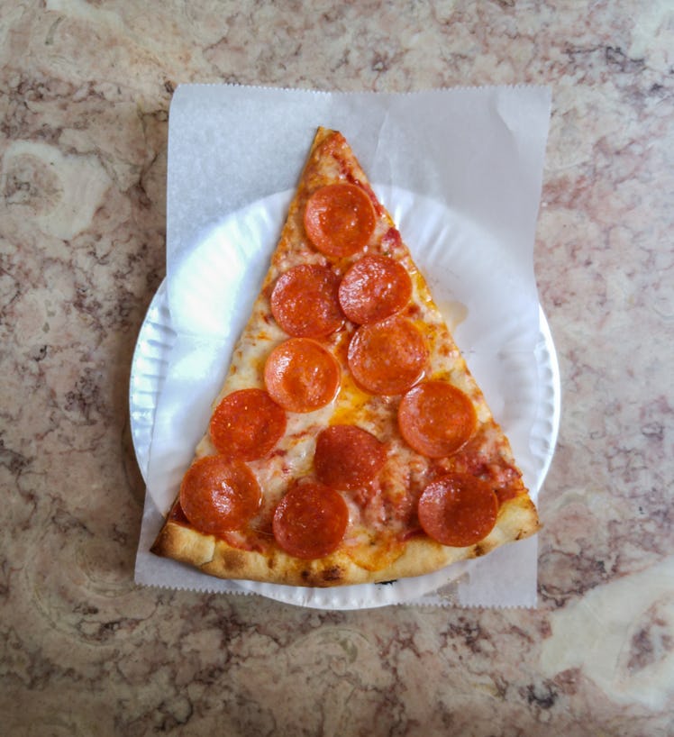 slice of pizza on paper plate sodium salt