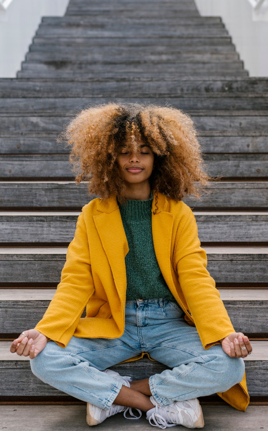 Young woman meditating to show each zodiac sign has a mantra.