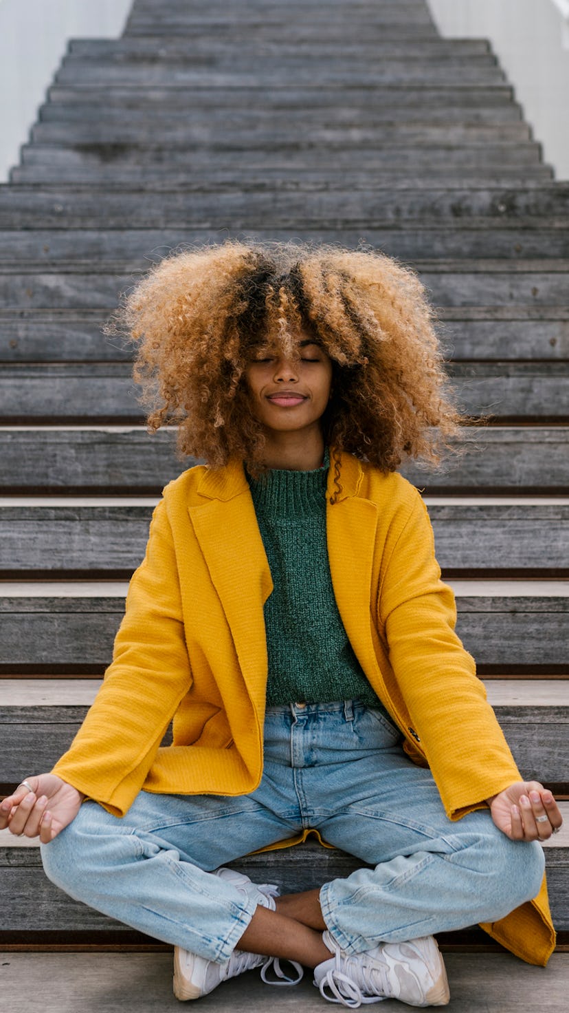 Young woman meditating to show each zodiac sign has a mantra.