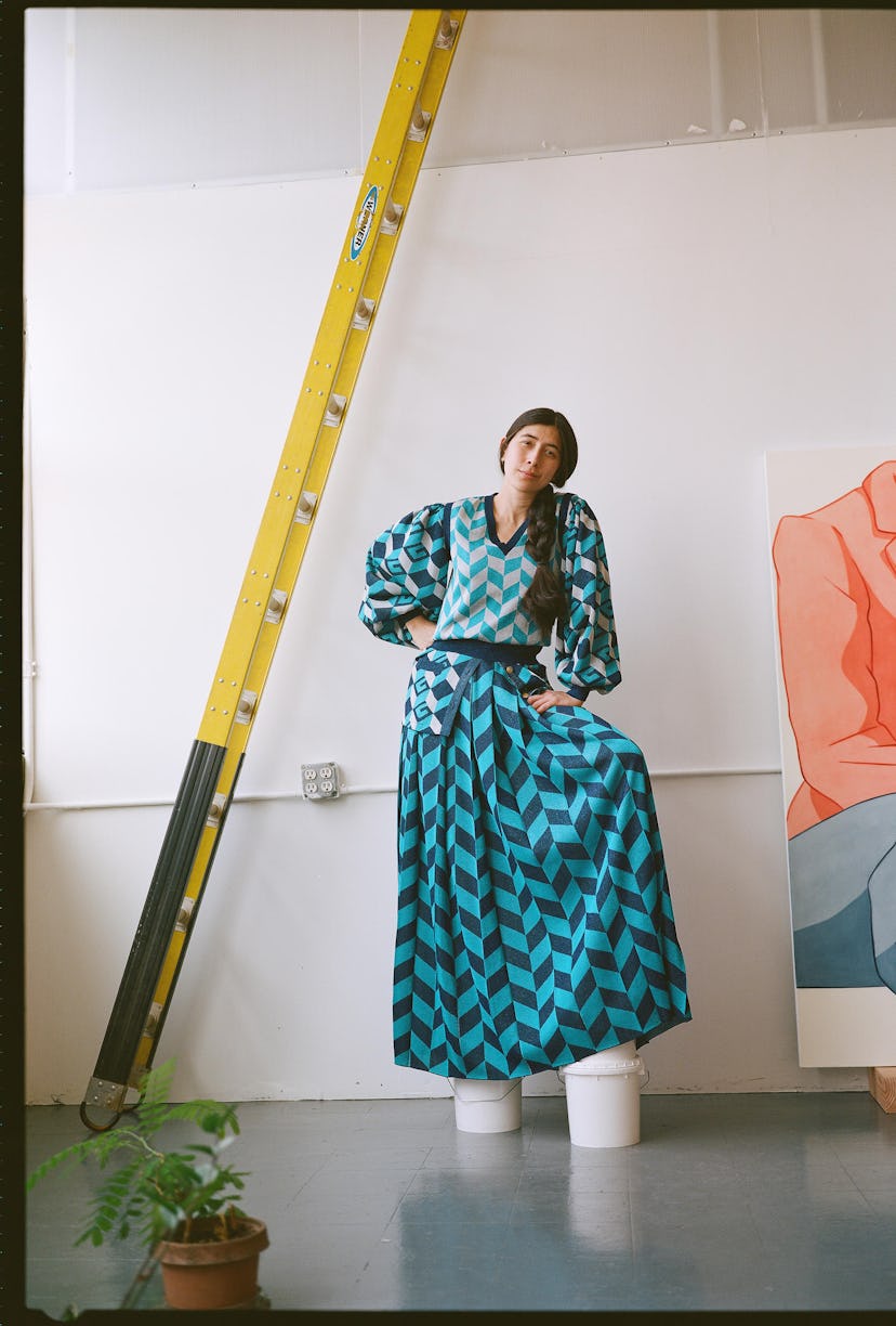 Ivy Haldeman wears a Gucci blouse, vest, and skirt; her own shoes in her studio.