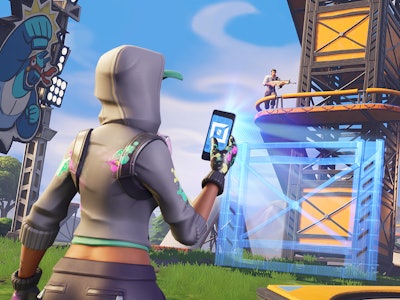 A character from Fortnite using a smartphone and taking a picture with a defense tower in the backgr...