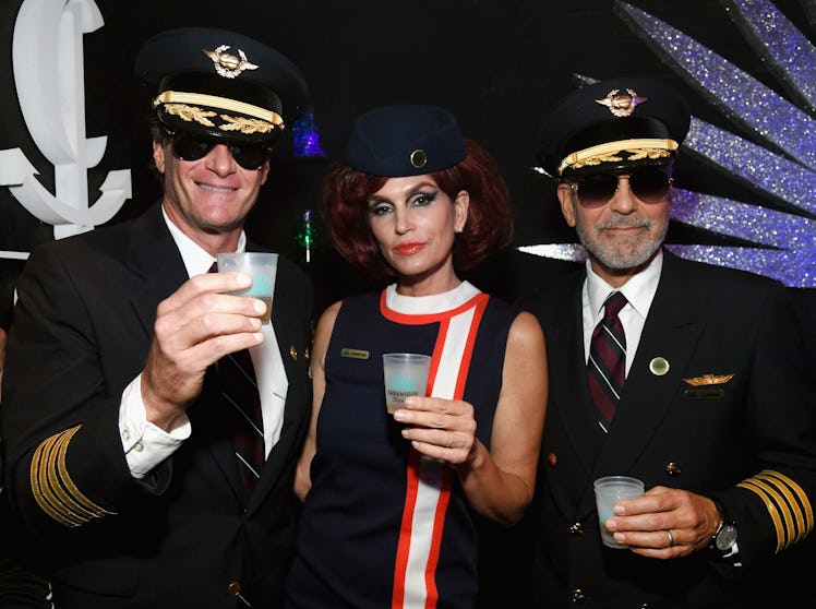 Rande Gerber in a pilot uniform, Cindy Crawford in a flight attendant uniform, George Clooney in a p...