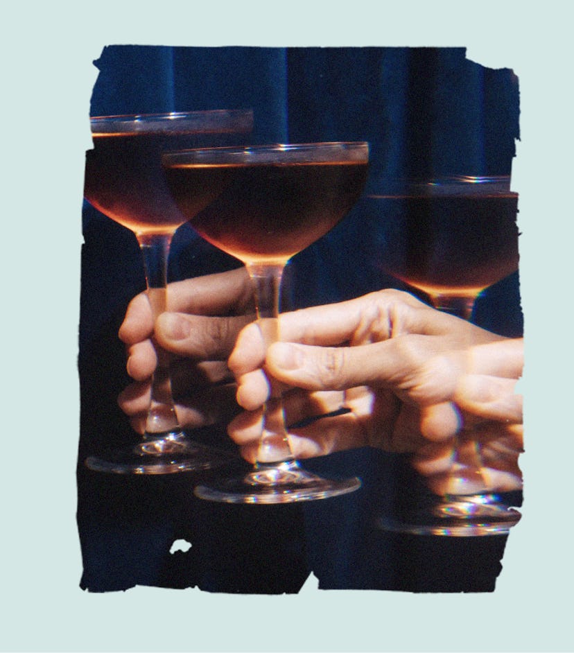 A person's hand holds up a glass of dark liqueur. Here's how Millennial women feel about sobriety in...