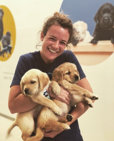 Female researcher holds puppies