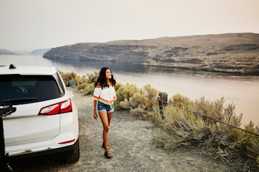 Young woman taking in the scenery, nature uses view captions for Instagram for the landscape. 