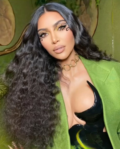 Kim Kardashian with crimped hair in green jacket