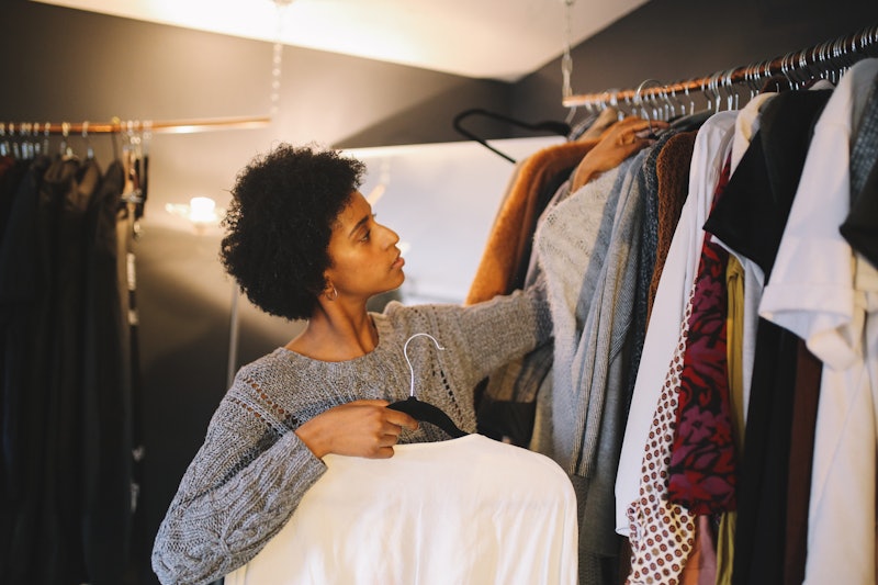 Woman looks in her wardrobe.