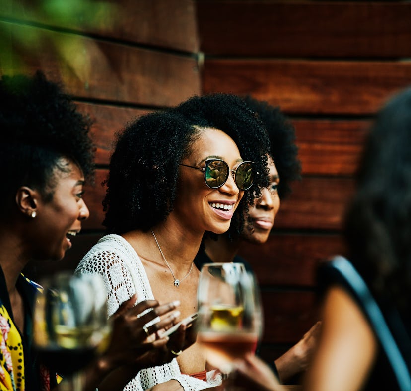 Young women drinking during happy hour, in need of Instagram captions.