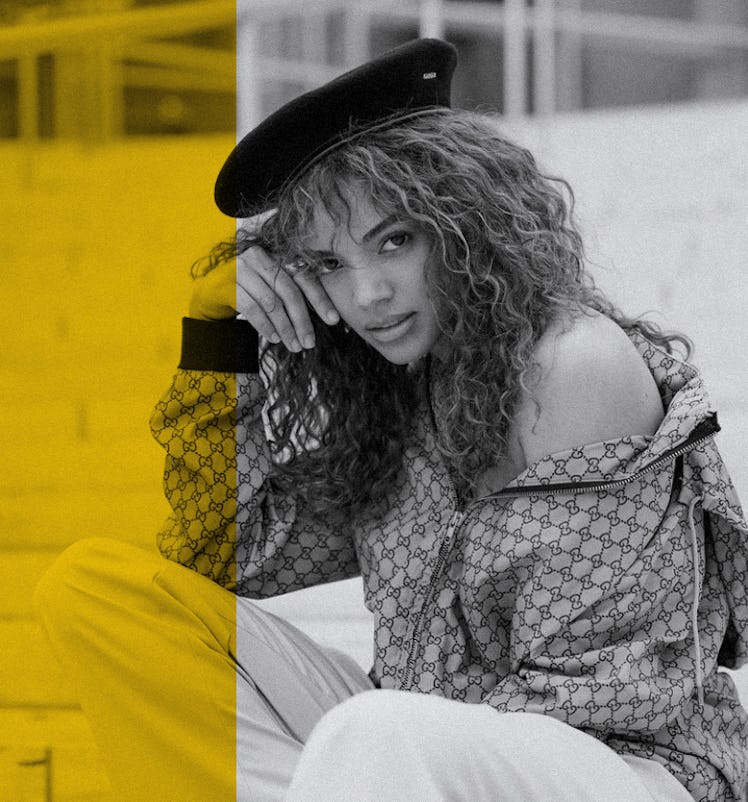 Full-profiled Leslie Grace posing with her curly hairstyle