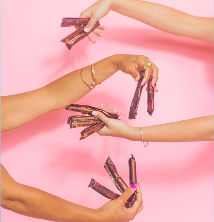 Two pair of hands holding August tampons