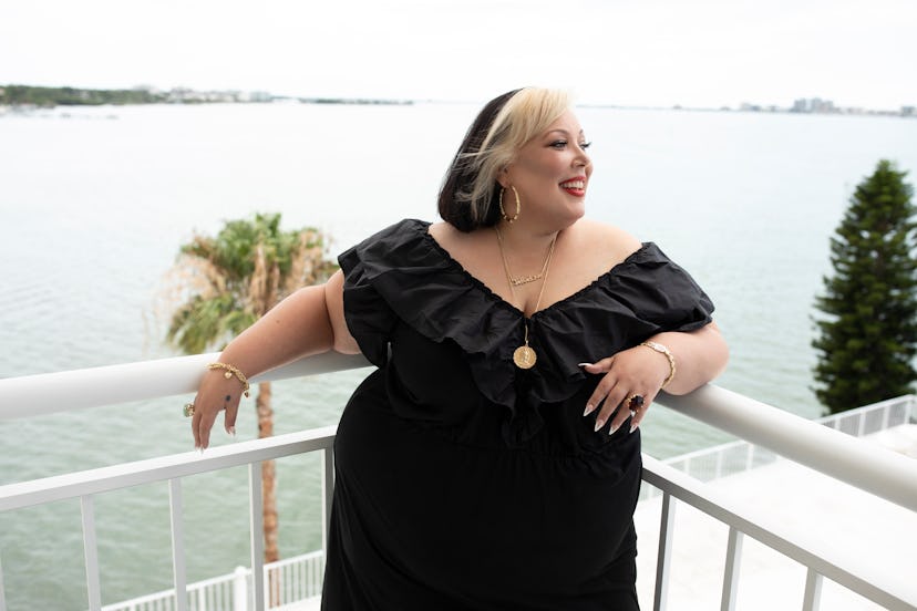 Jae Rae posing in a black dress at the terrace of her home in Florida