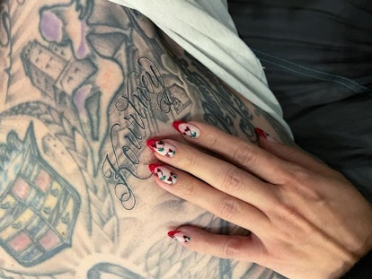 Kourtney Kardashian red cherry nails with Travis Barker tattoo