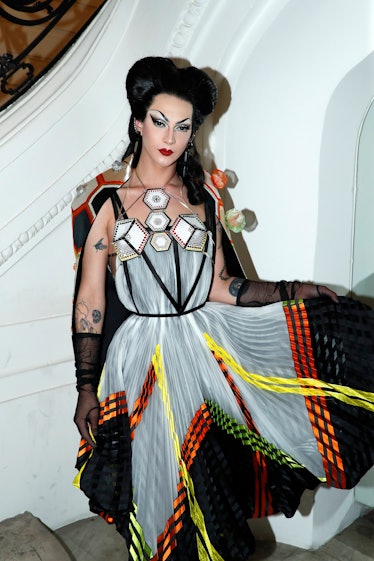 Violet Chachki in pin-up style in a white-orange-black dress with abstract elements at the Jean Paul...