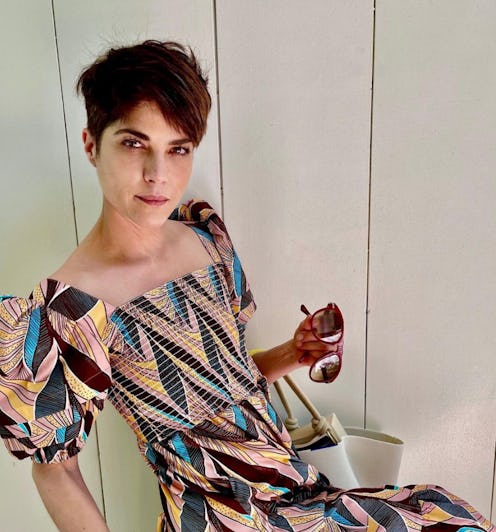 selma blair posing in a printed dress with dark hair