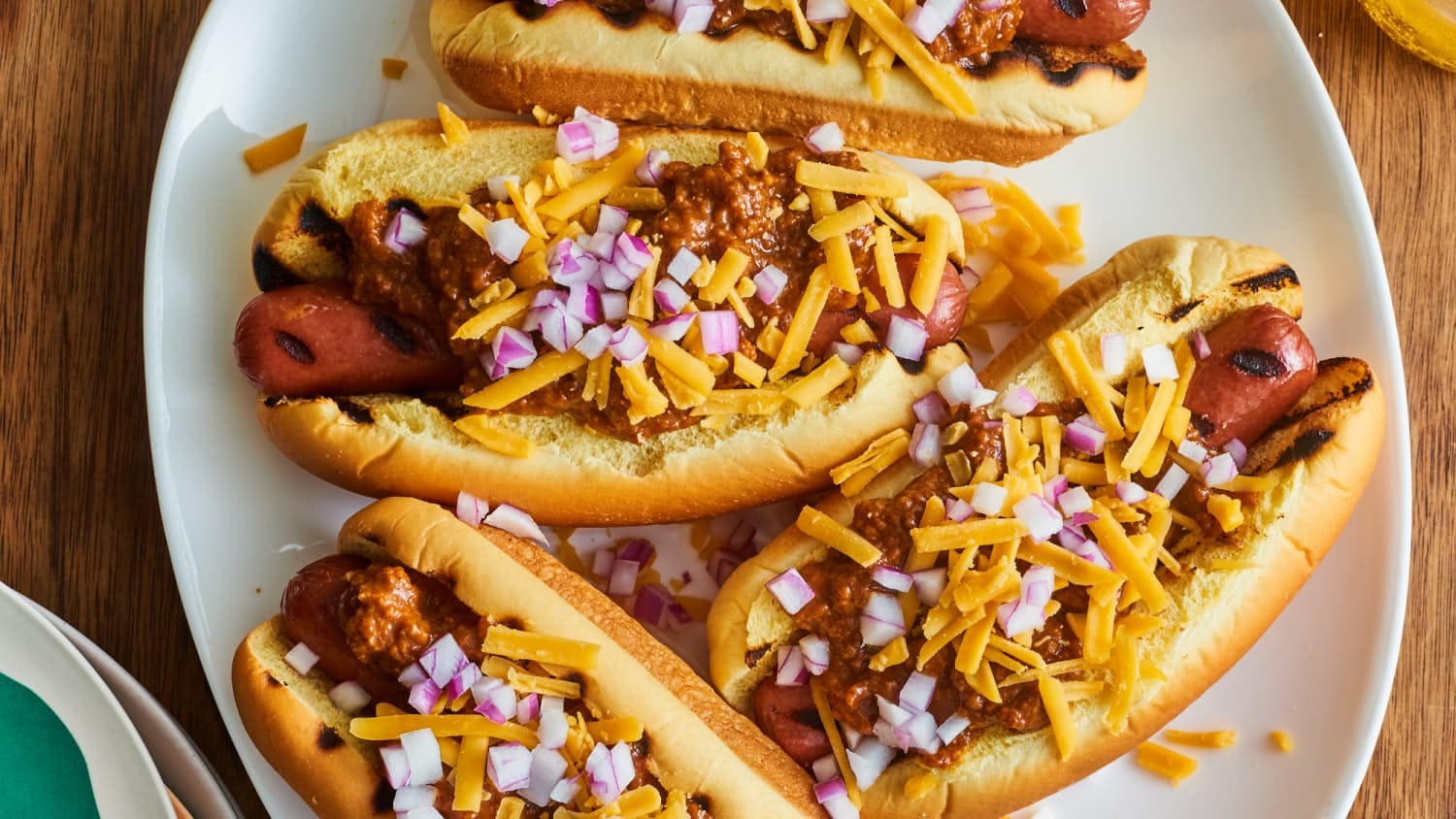 Chili hot dogs served on a plate
