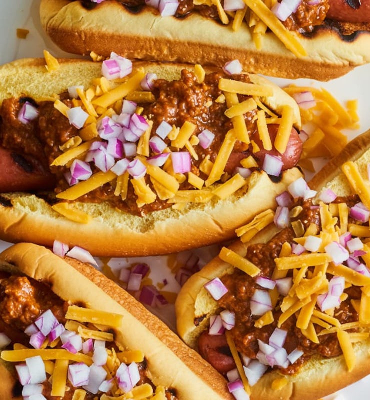 Chili hot dogs served on a plate