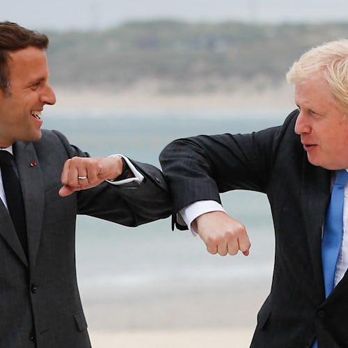  Britain's Prime Minister Boris Johnson (R) greets France's President Emmanuel Macron during the G7 ...