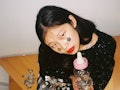 Young woman playing with coins and a baby bottle to show how old she is mentally, according to her z...