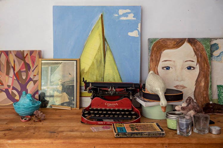 typewriter and paintings on a desk
