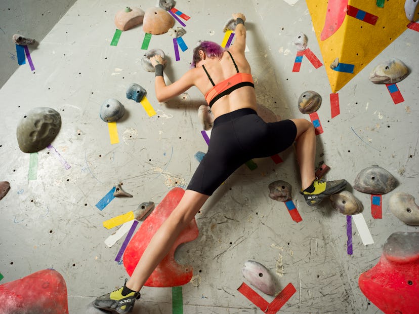 Woman rock climbing in Adidas Techfit Period Proof shorts