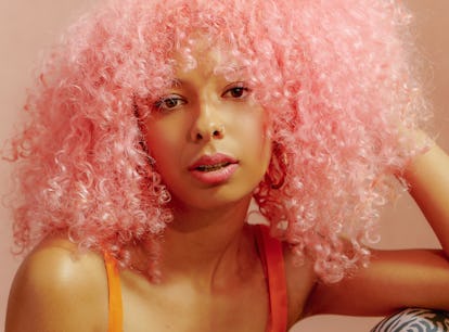 Young woman with pink hair, looking like an ethereal goddess, per her zodiac sign.