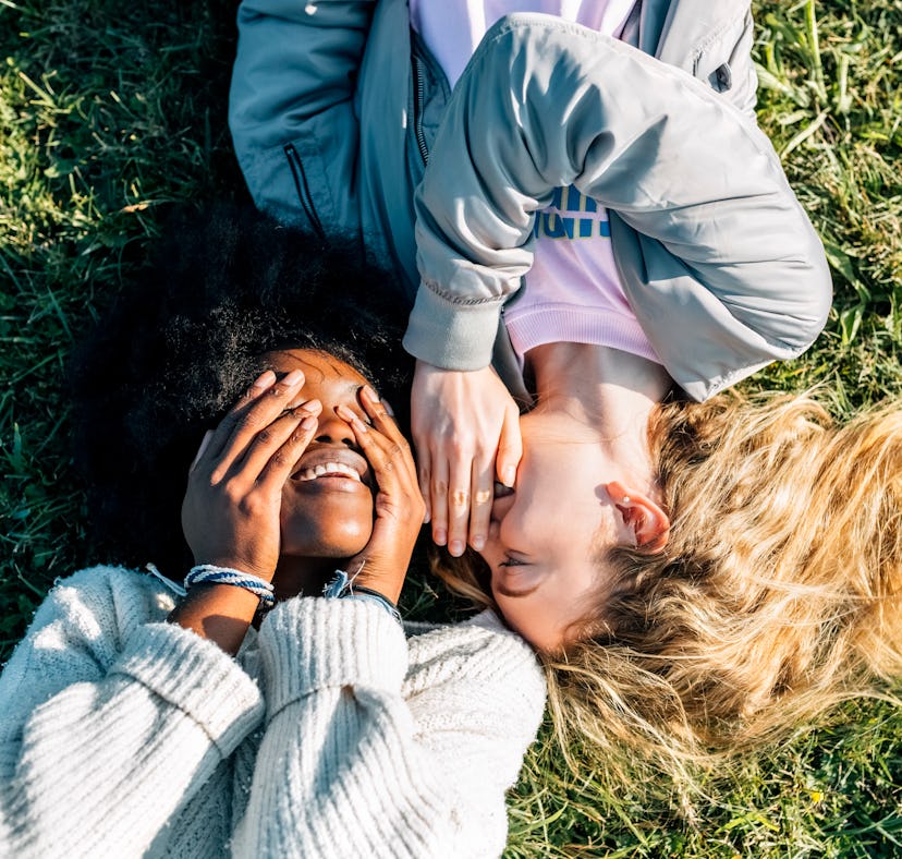 2 best friends laying in the grass, telling secrets on a Saturday before posting a pic on Instagram ...