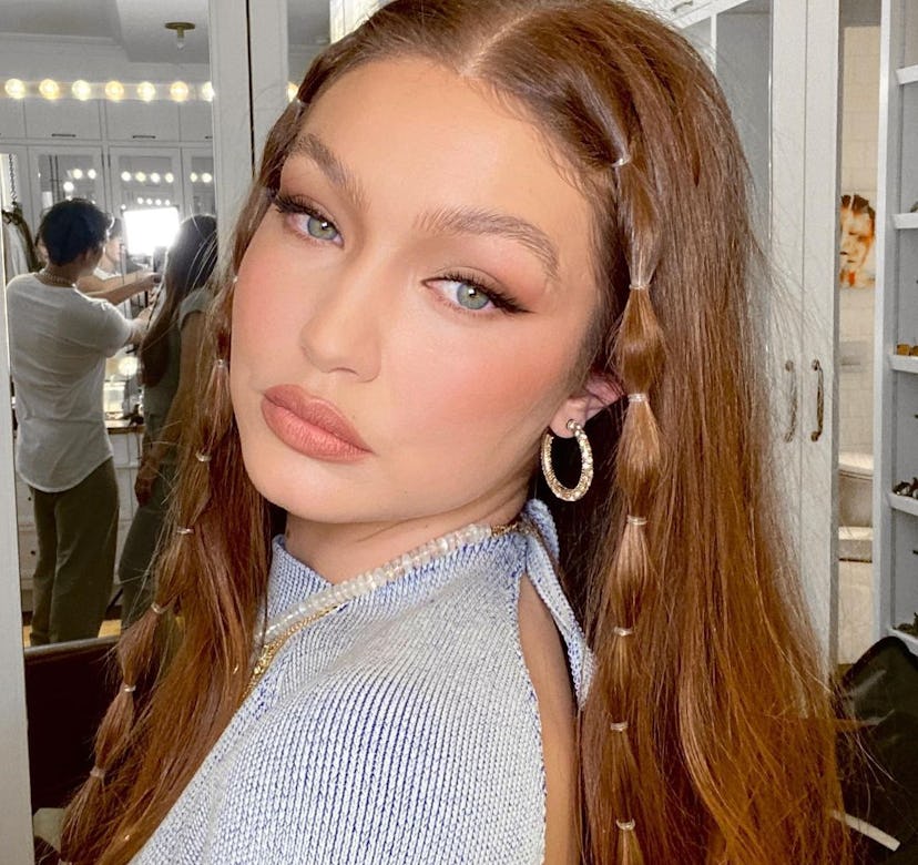 Gigi Hadid posing with long red hair
