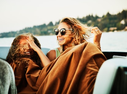 2 young friends smiling on a boat, laughing at boat puns, sailing puns, & ship puns.