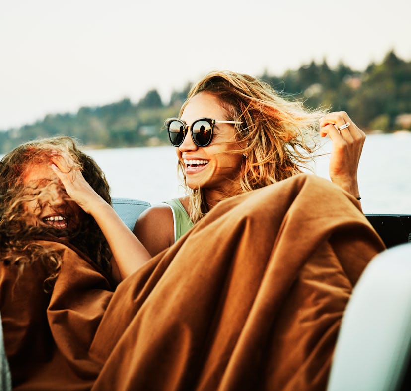 2 young friends smiling on a boat, laughing at boat puns, sailing puns, & ship puns.