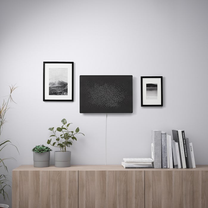 a black picture frame is hanging on a white wall