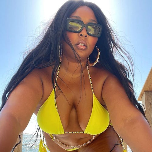 Lizzo wears bikini and golden chain.