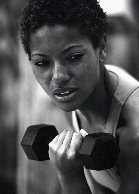 A woman lifting dumbbell during her workout