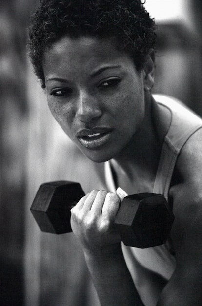 A woman lifting dumbbell during her workout