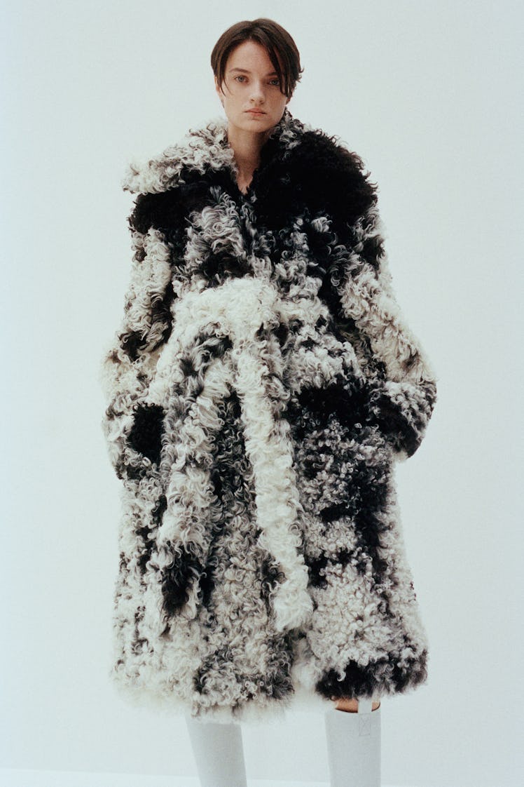 A woman posing in a black and white Proenza Schouler fur coat