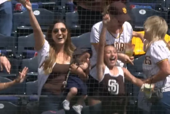 Padres fan, Lexy Whitmore, catches foul ball with her baby, Maverick in her arm during the June 9 ga...