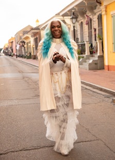 The Musician Big Freedia dressed in white and standing on the street in New Orleans