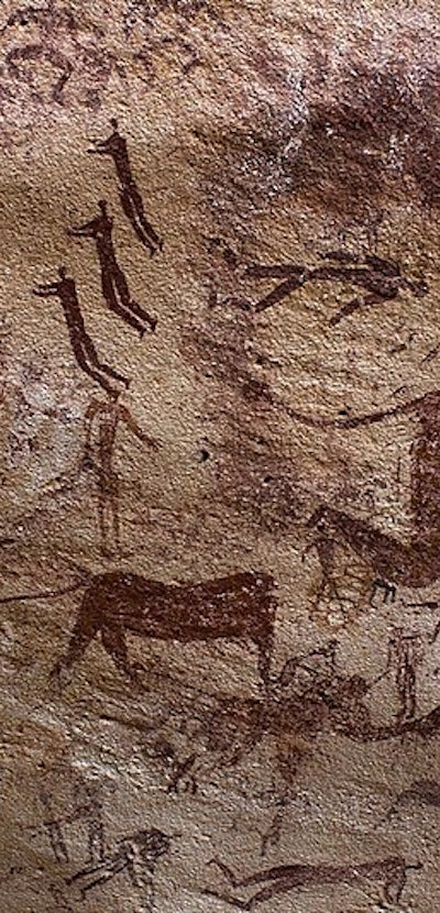 Paintings of human figures and animals on a brown cave wall