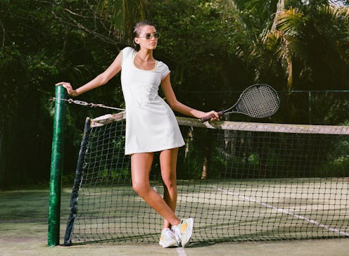 Model wearing white tennis dress from the New Balance x STAUD collaboration.