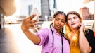 2 friends taking an elegant selfie to post on Instagram with a fabulous caption.