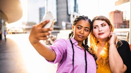 2 friends taking an elegant selfie to post on Instagram with a fabulous caption.