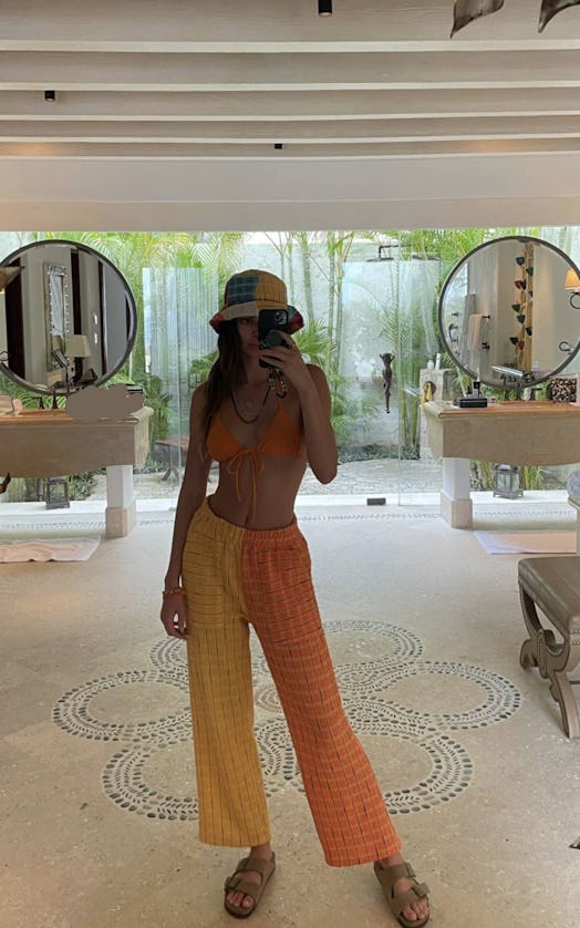 Kendall Jenner in orange and yellow lounge pants
