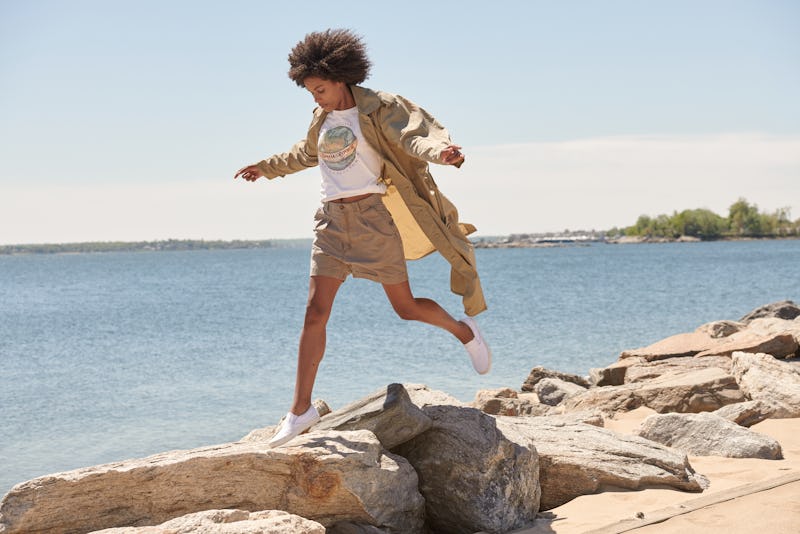 Woman in vintage banana republic clothing walking next to the sea