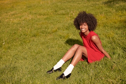 Woman in vintage banana republic clothing sitting in the grass