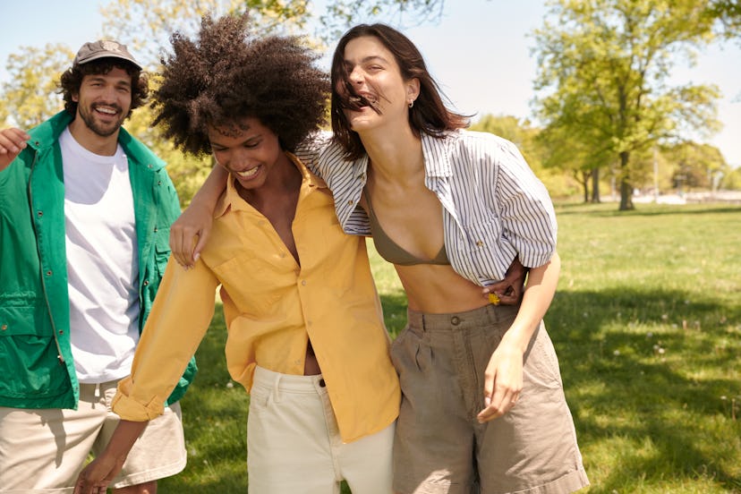 Three people in vintage banana republic outfits hanging out in the park