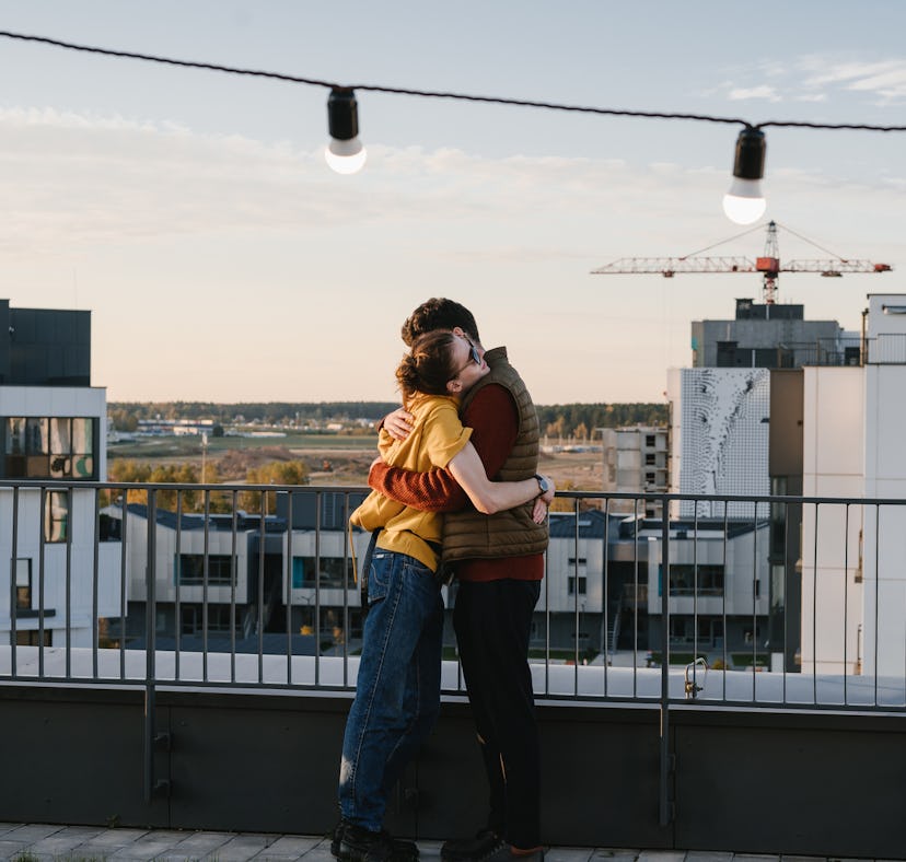 Young woman hugging her partner after getting one of the best gifts for Cancer.