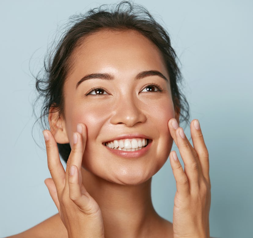 Model touching face in a photo.